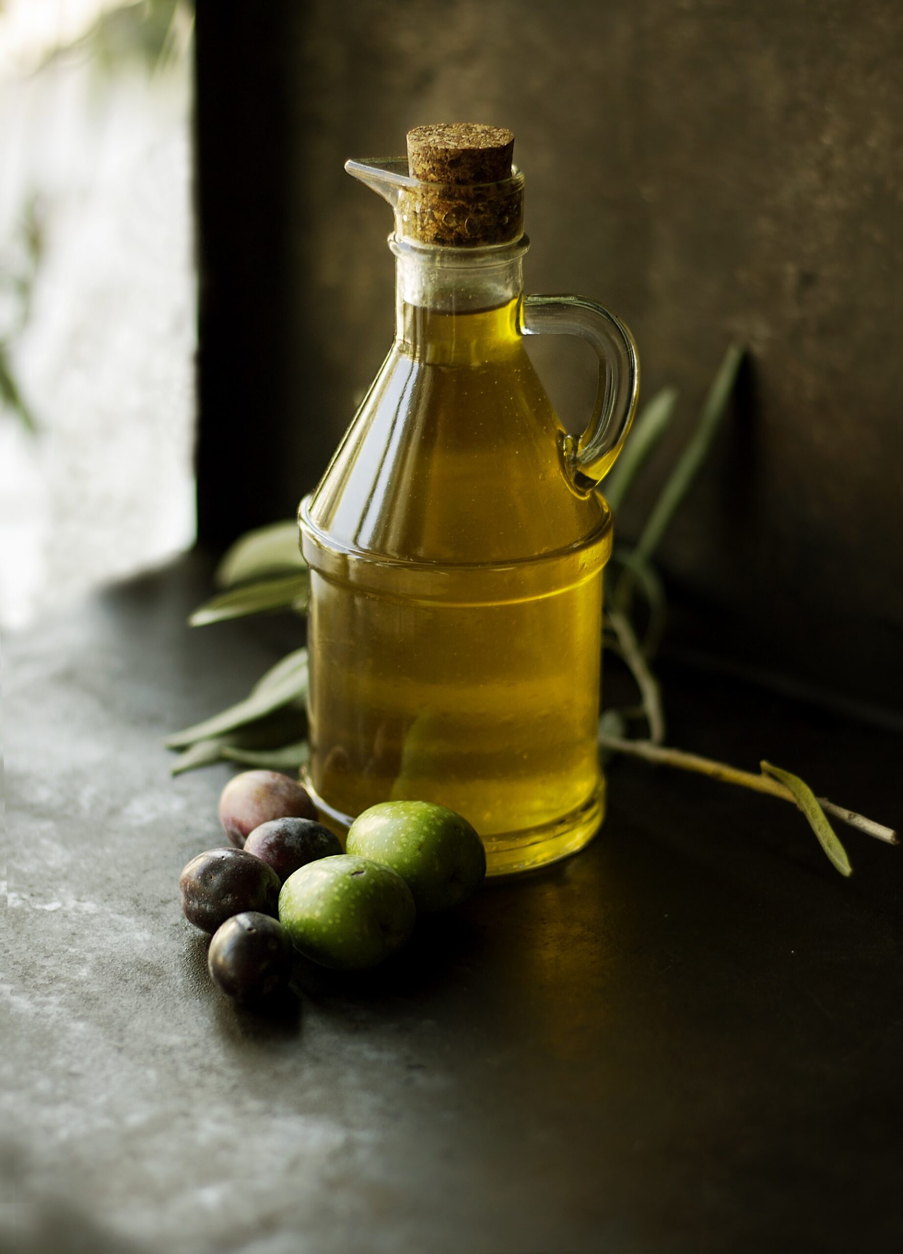 jar of olive oil with olives